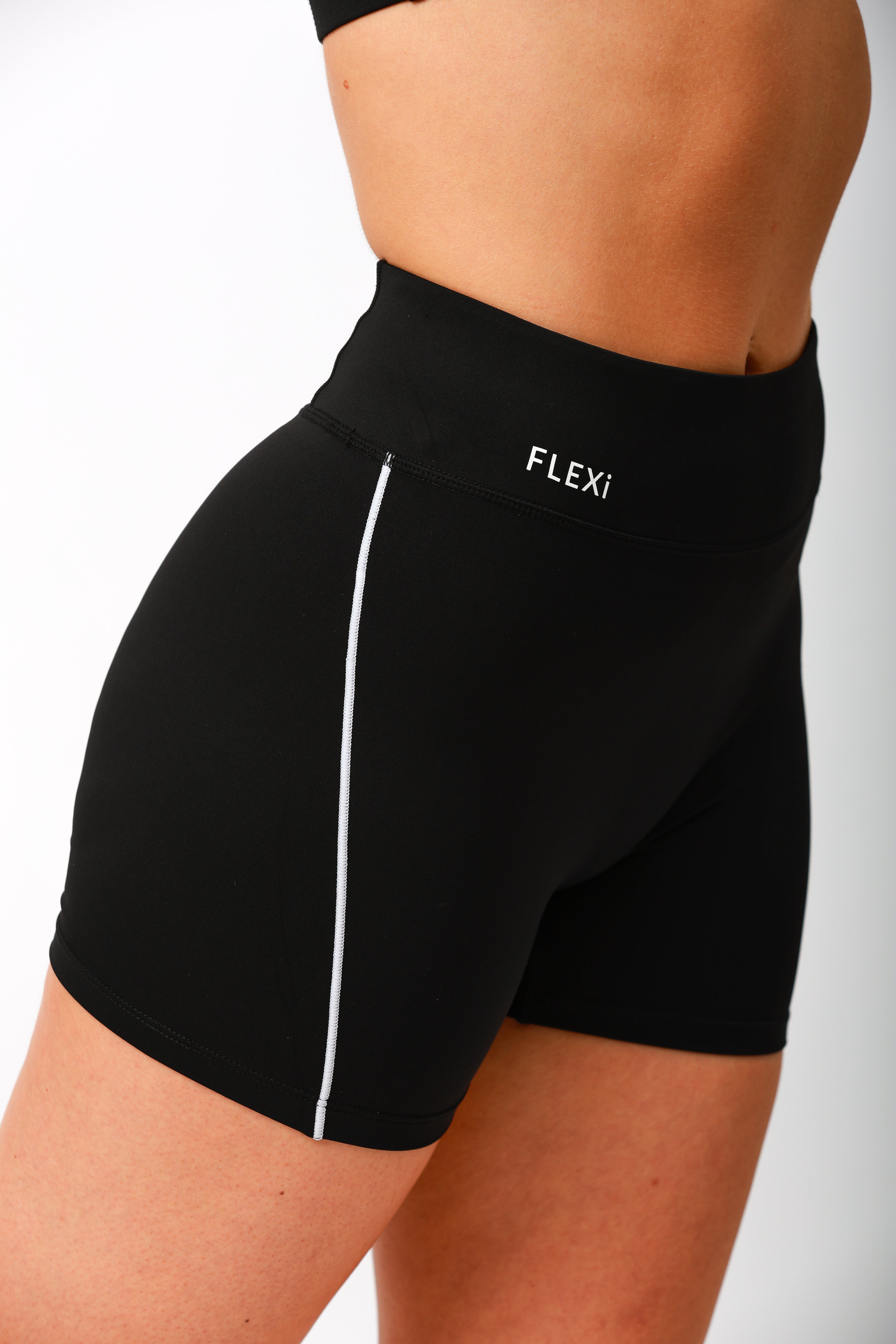 Model wearing FLEXi Flex ‘n’ Flash black dance shorts with bold white stripe