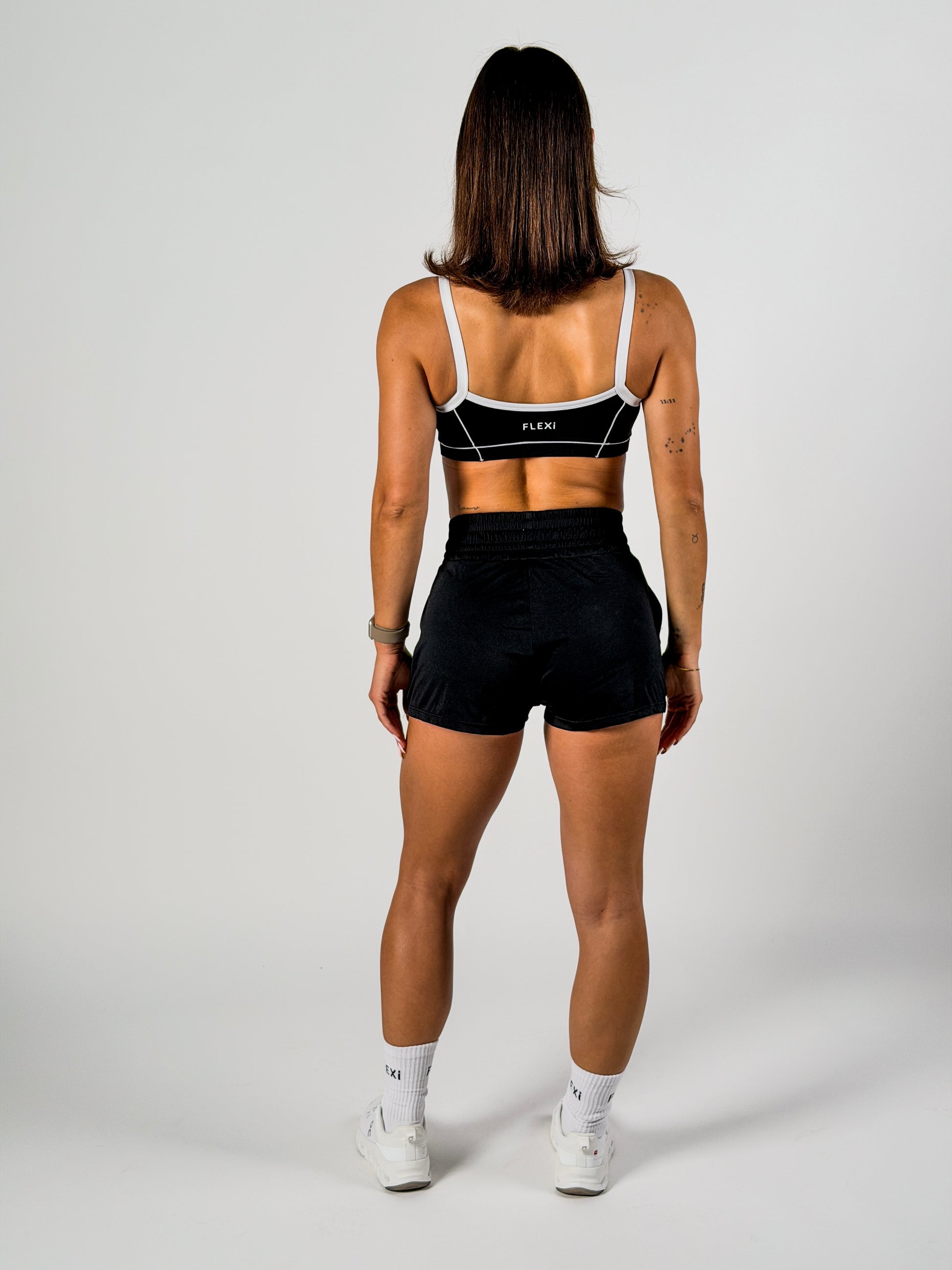 Girls’ black dance outfit including sports bra and shorts, flexible and comfortable.